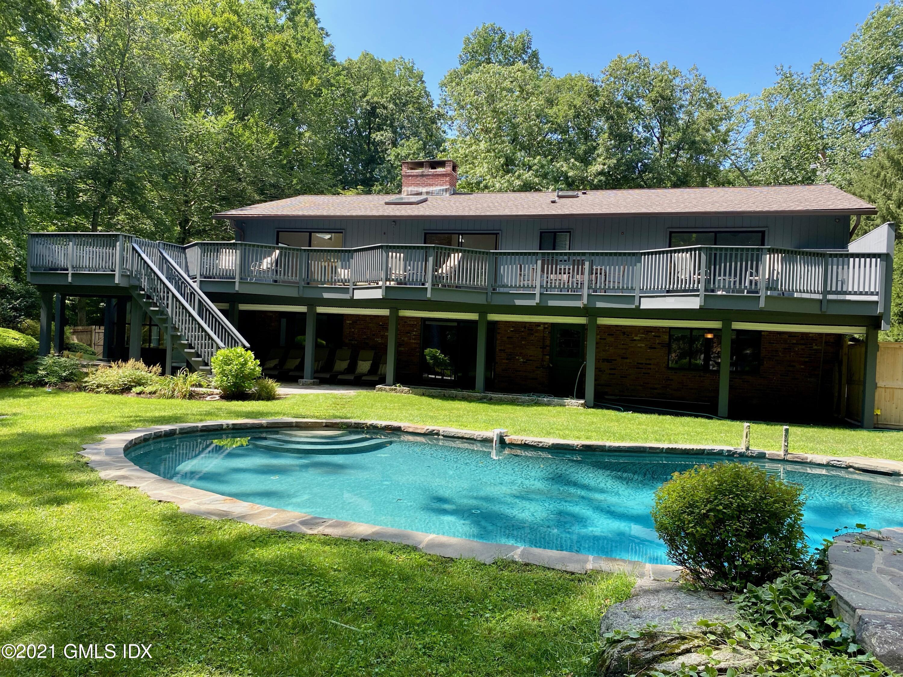297 Cognewaugh Road Cos Cob, CT 06807 - Photo 20 of 25 a view of a house with a swimming pool