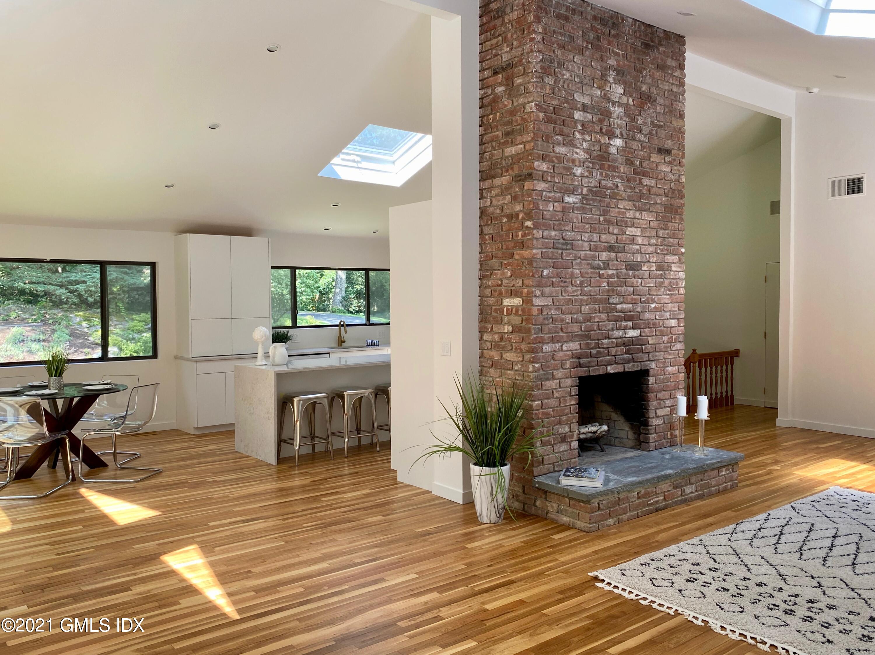 297 Cognewaugh Road Cos Cob, CT 06807 - Photo 2 of 25 a living room with furniture and a fireplace