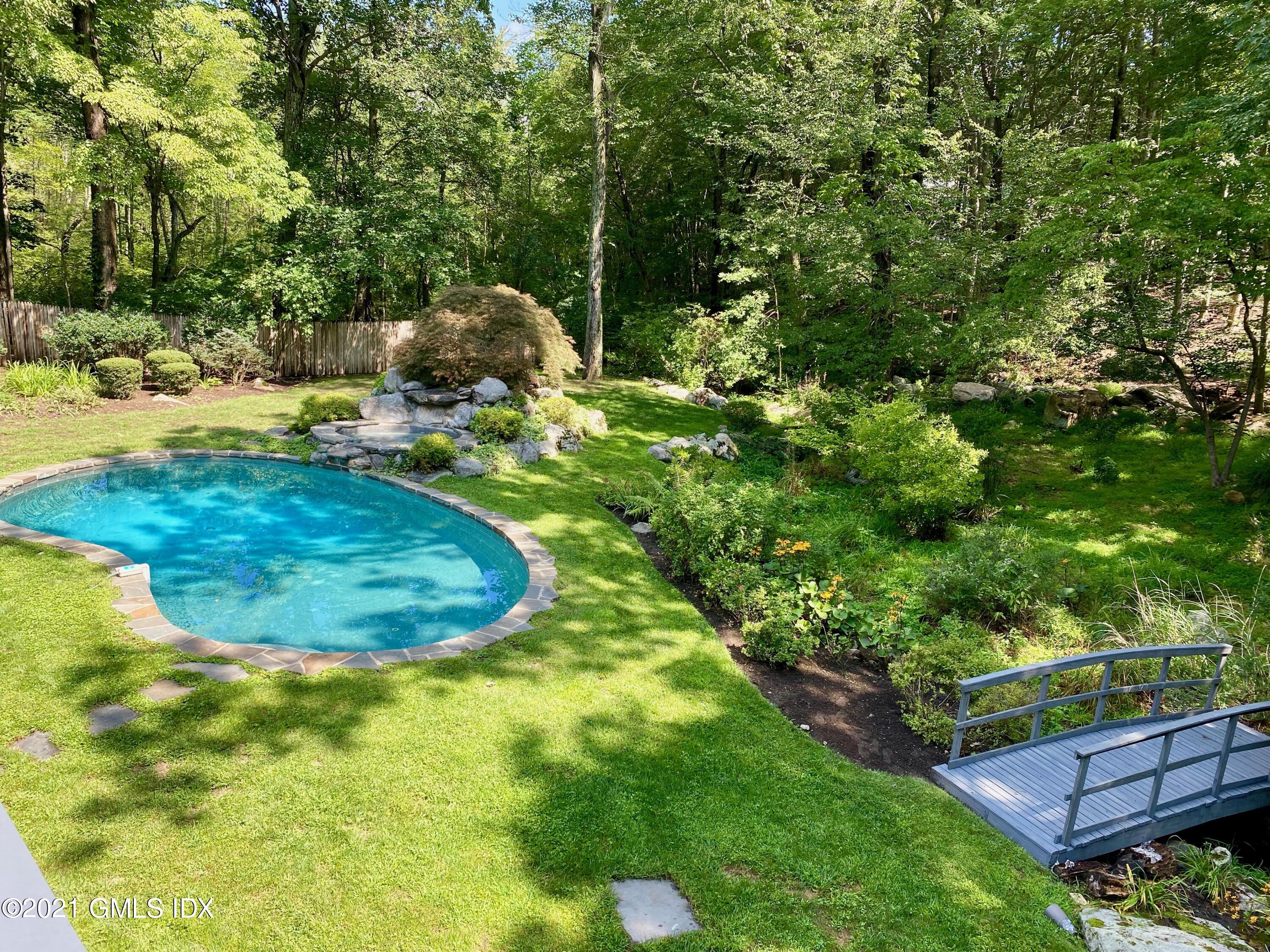 297 Cognewaugh Road Cos Cob, CT 06807 - Photo 21 of 25 a view of a backyard with swimming pool
