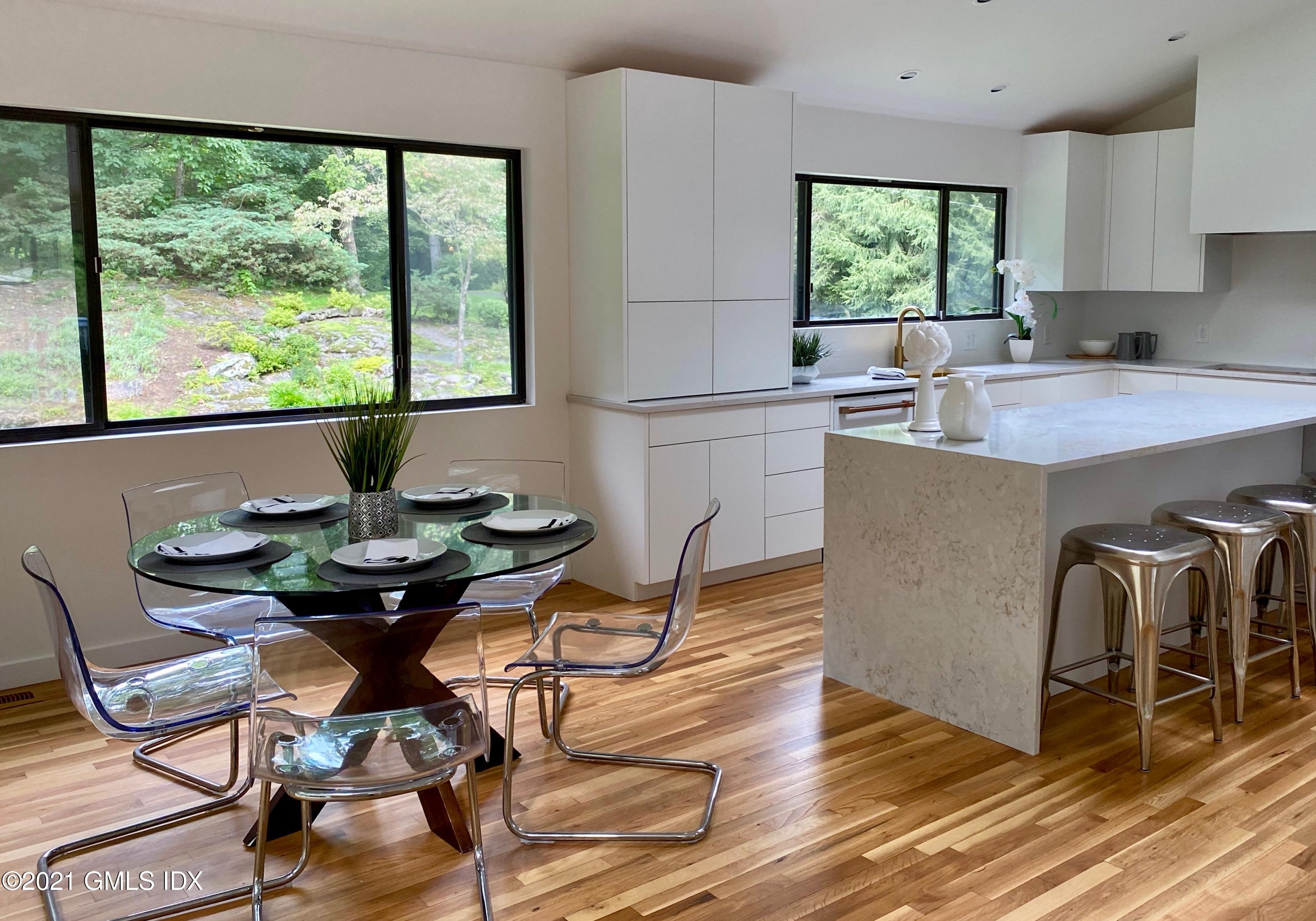 297 Cognewaugh Road Cos Cob, CT 06807 - Photo 4 of 25 a view of a dining room with furniture window and outside view