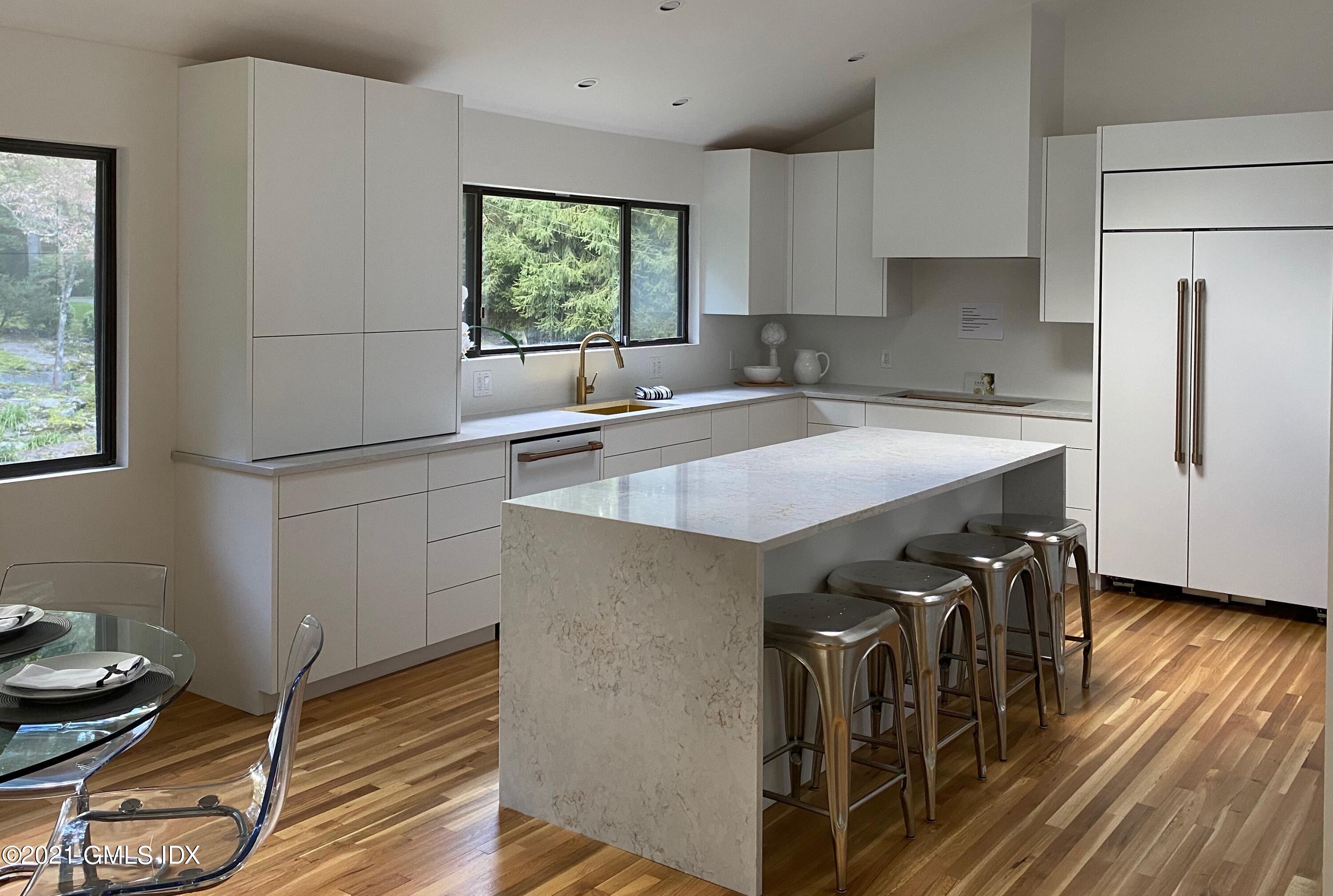 297 Cognewaugh Road Cos Cob, CT 06807 - Photo 5 of 25 a kitchen with a sink appliances and cabinets