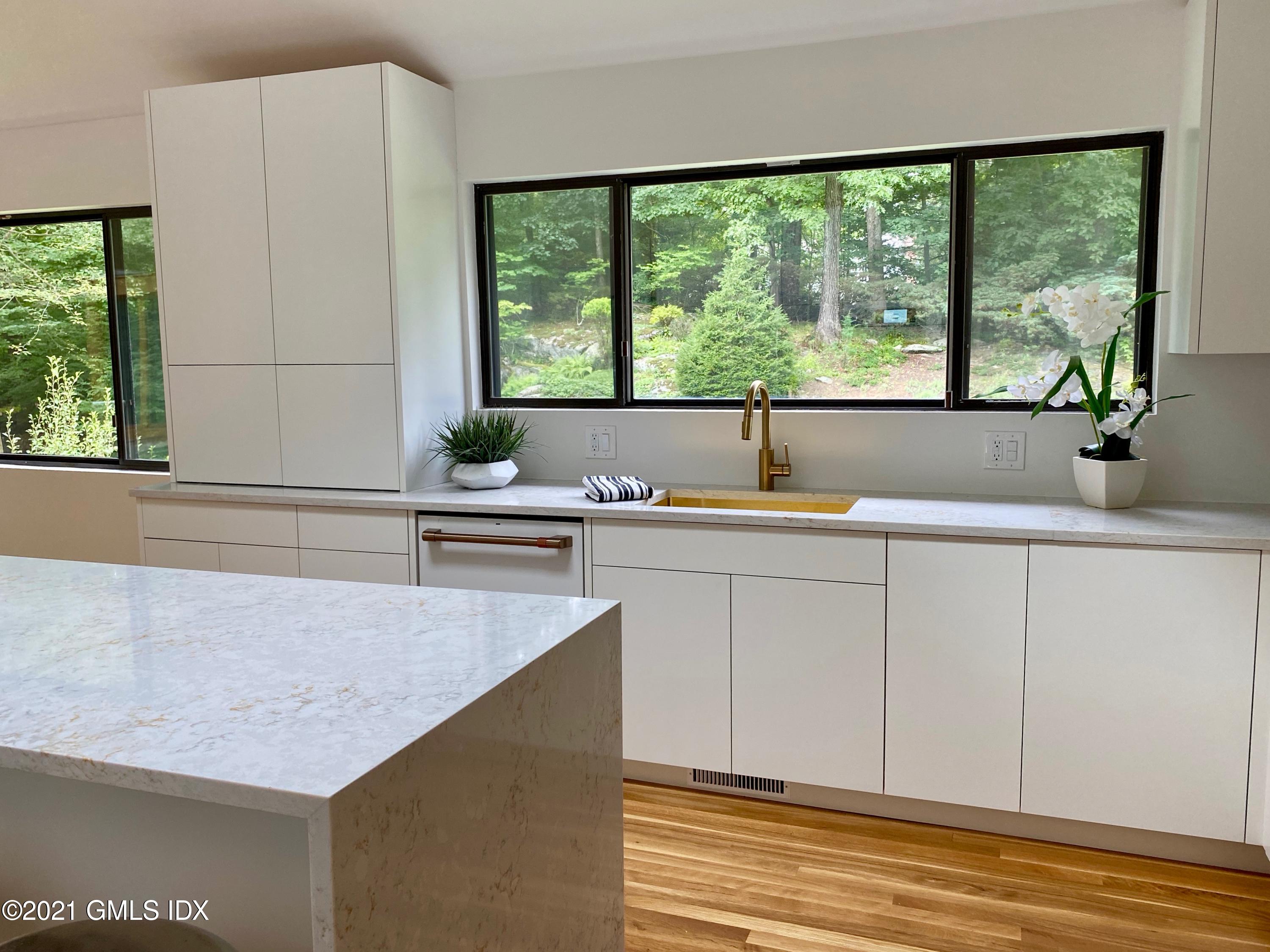 297 Cognewaugh Road Cos Cob, CT 06807 - Photo 6 of 25 a kitchen with a sink and large window