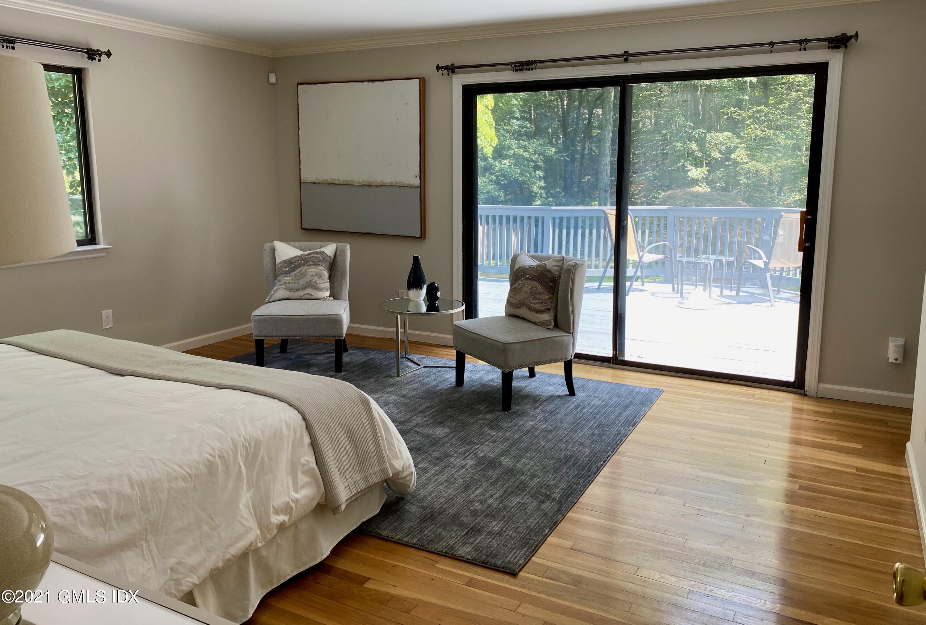 297 Cognewaugh Road Cos Cob, CT 06807 - Photo 8 of 25 a spacious bedroom with a bed and large window