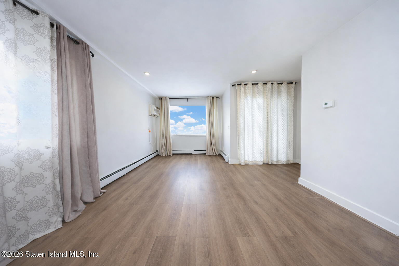 314 Harold Street Staten Island, NY 10314 - Photo 11 of 24 a view of wooden floor and windows in a room