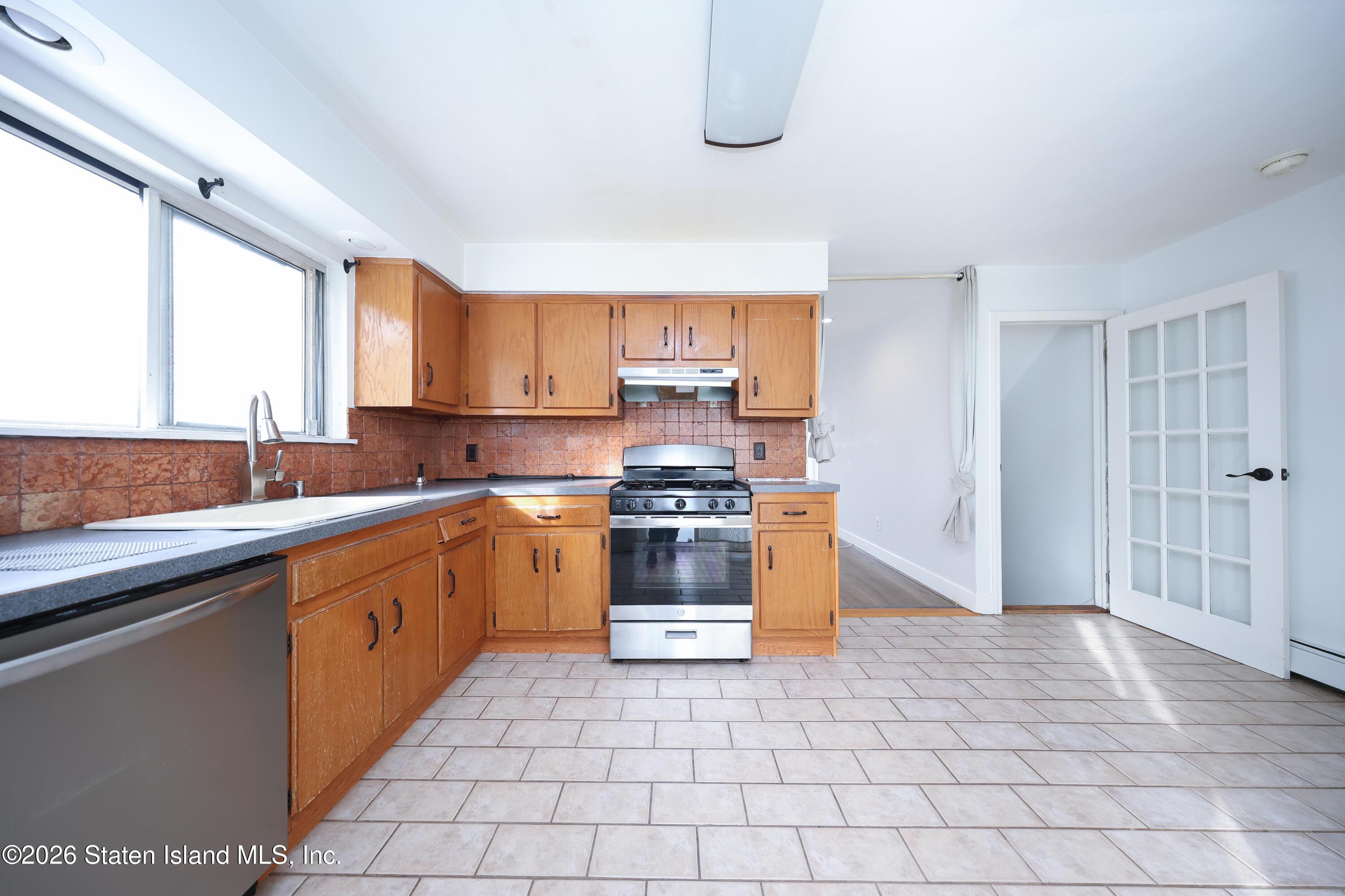 314 Harold Street Staten Island, NY 10314 - Photo 12 of 24 a kitchen with stainless steel appliances granite countertop a stove a sink and a microwave