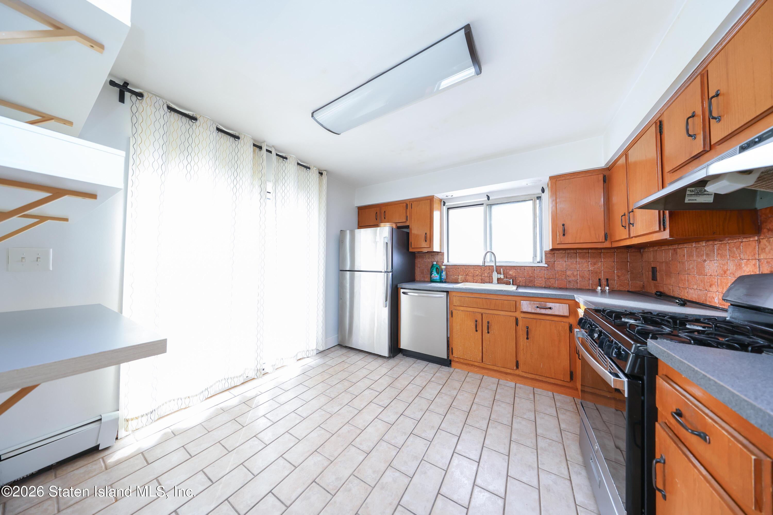 314 Harold Street Staten Island, NY 10314 - Photo 14 of 24 a kitchen with granite countertop a refrigerator stove top oven and sink