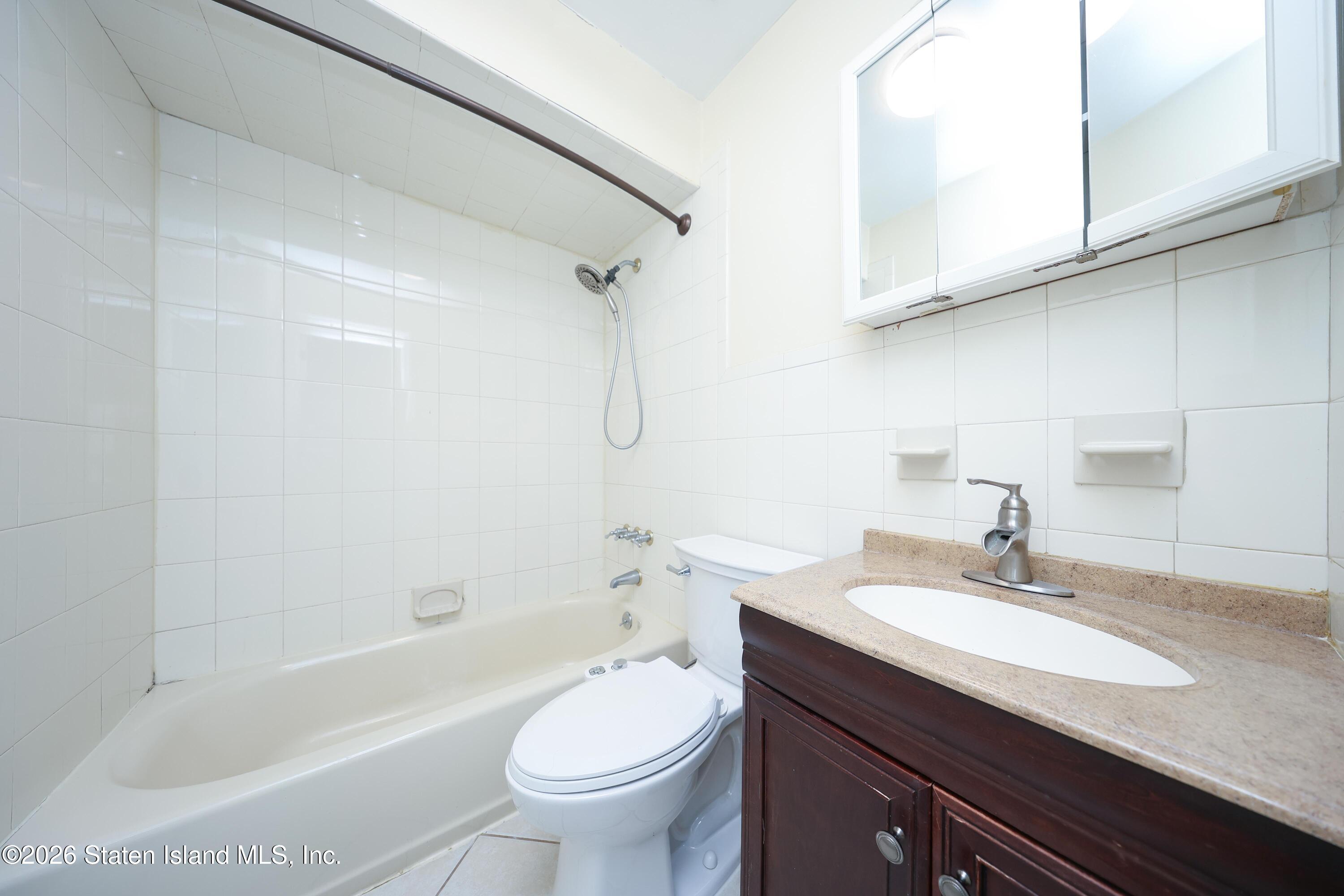 314 Harold Street Staten Island, NY 10314 - Photo 19 of 24 a bathroom with a sink a toilet and a bathtub