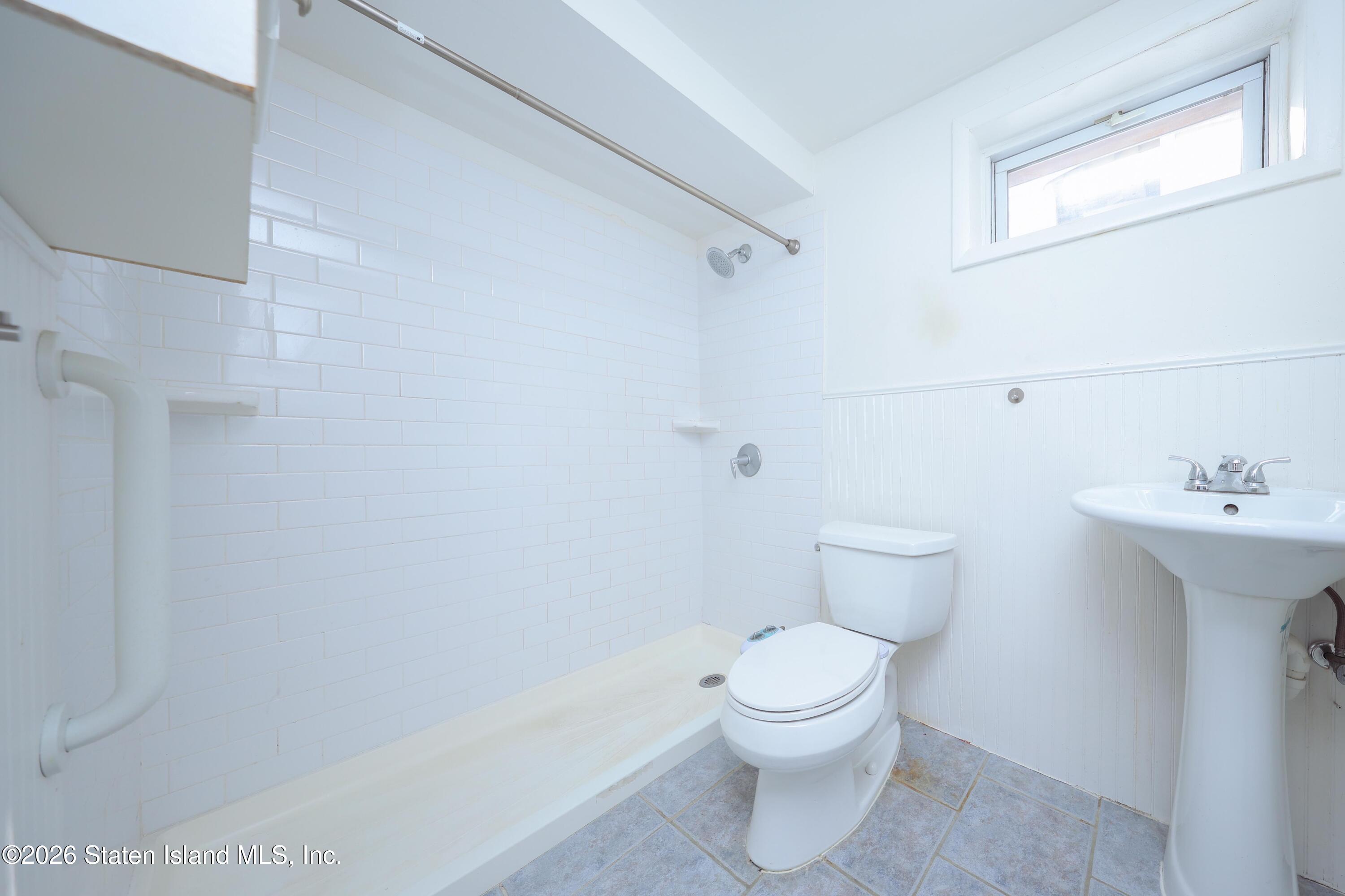 314 Harold Street Staten Island, NY 10314 - Photo 22 of 24 a white toilet sitting next to a bathroom sink