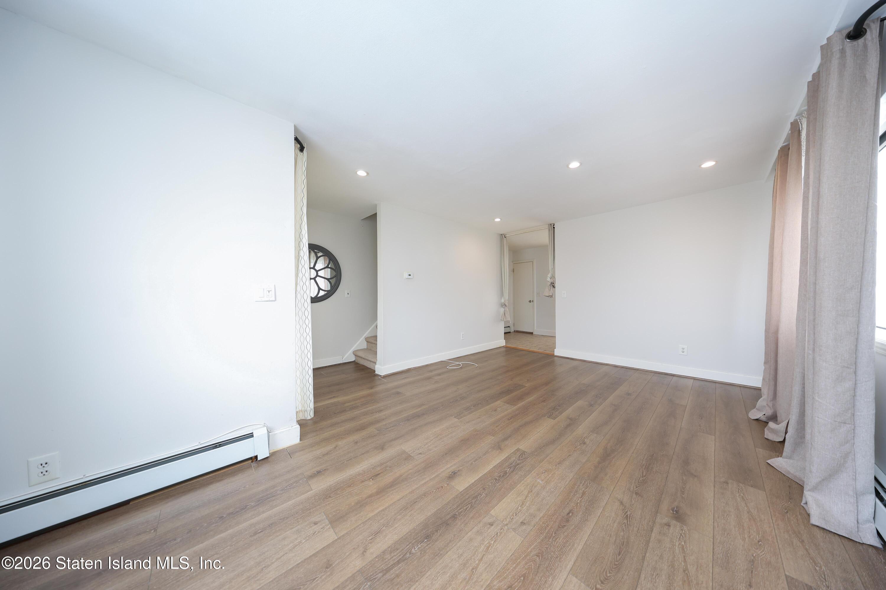 314 Harold Street Staten Island, NY 10314 - Photo 8 of 24 an empty room with wooden floor and entrance