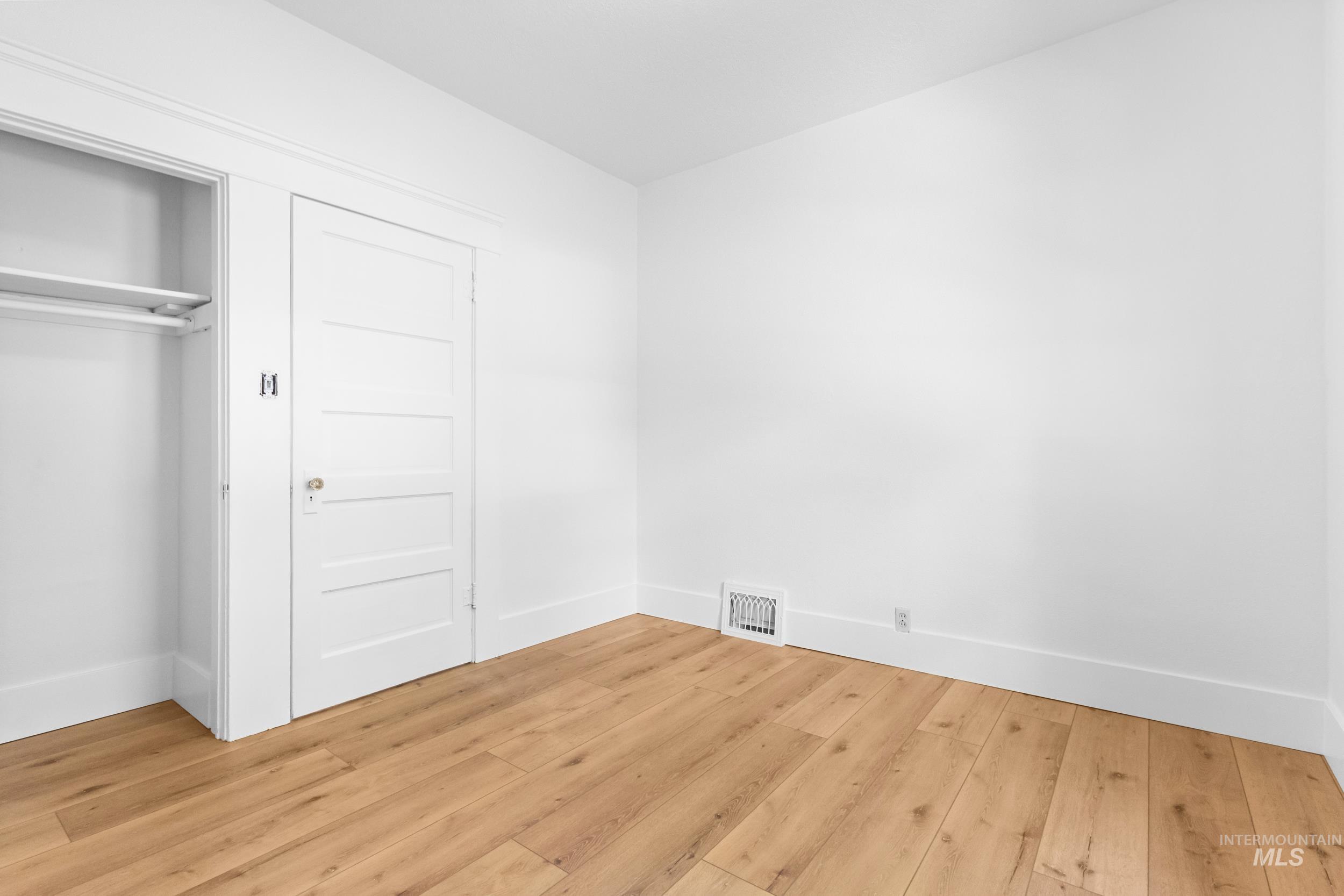 2119 West Brumback Street Boise, ID 83702 - Photo 21 of 30 Room featuring wood-finish flooring, white walls, and bright trim
