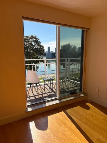 a view of a balcony with floor to ceiling window with wooden floor