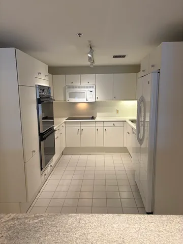 a kitchen with a refrigerator and a sink