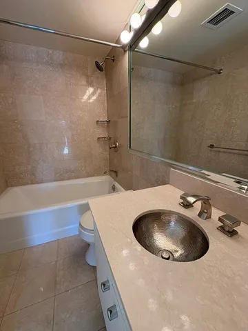 a bathroom with a sink and mirror