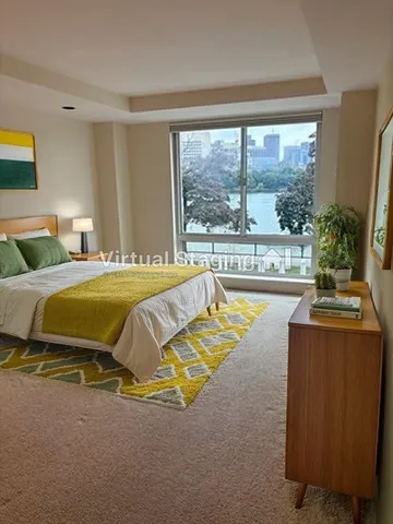 a bedroom with a bed and a night stand