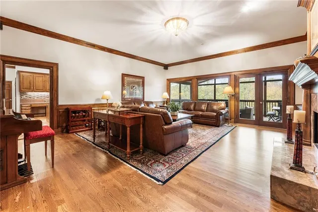 a spacious bathroom with a double vanity sink a mirror a bathtub and next to a window
