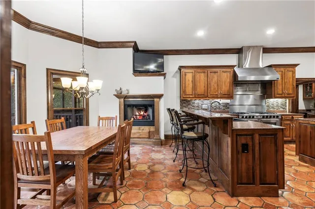 a living room with furniture a rug kitchen view and a window