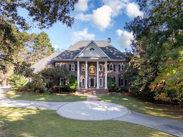 a view of a yard with large trees