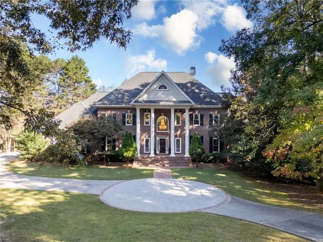 a view of a yard with large trees