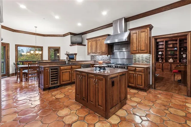 a room with pool table flat screen tv and couches