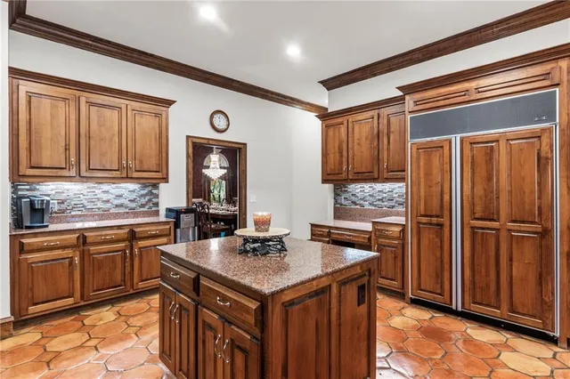 a spacious bedroom with a bed and a chandelier