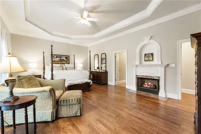 a bedroom with a bed and painting on the wall