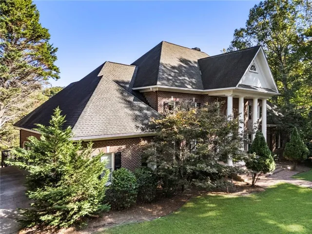 a living room with fireplace furniture and a large window