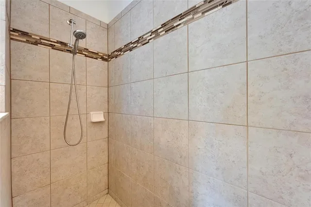 a bathroom with a granite countertop sink a toilet and shower