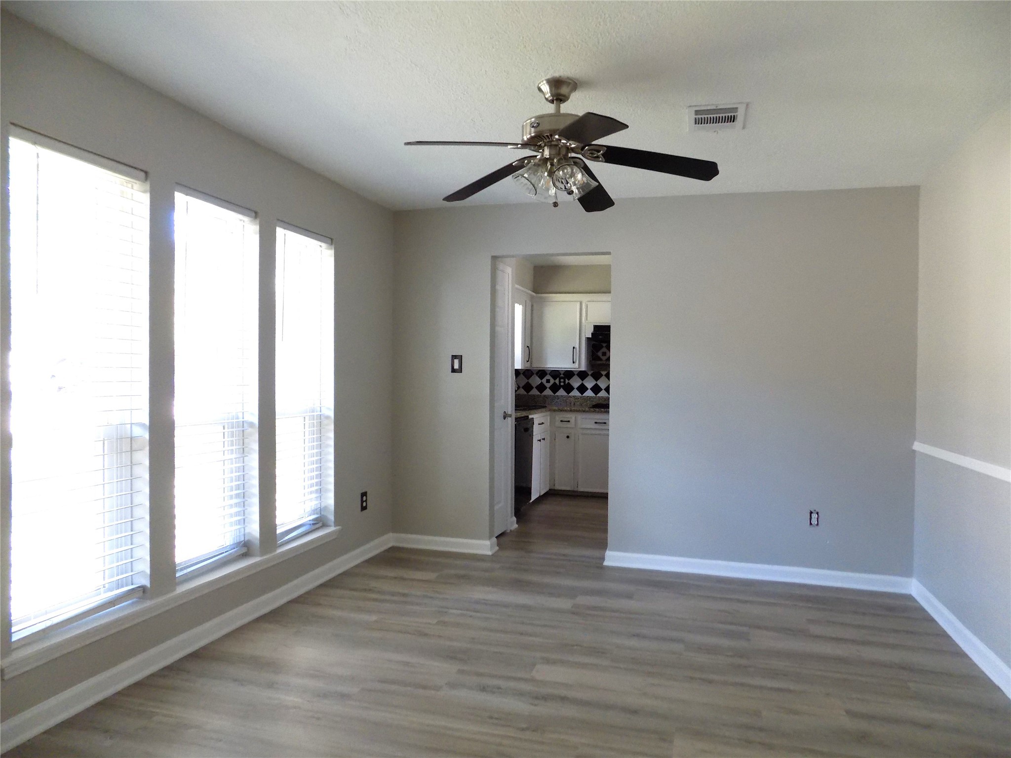 803 Wild Horse Valley Road Katy, TX 77450 - Photo 11 of 26 a view of an empty room with a window and wooden floor