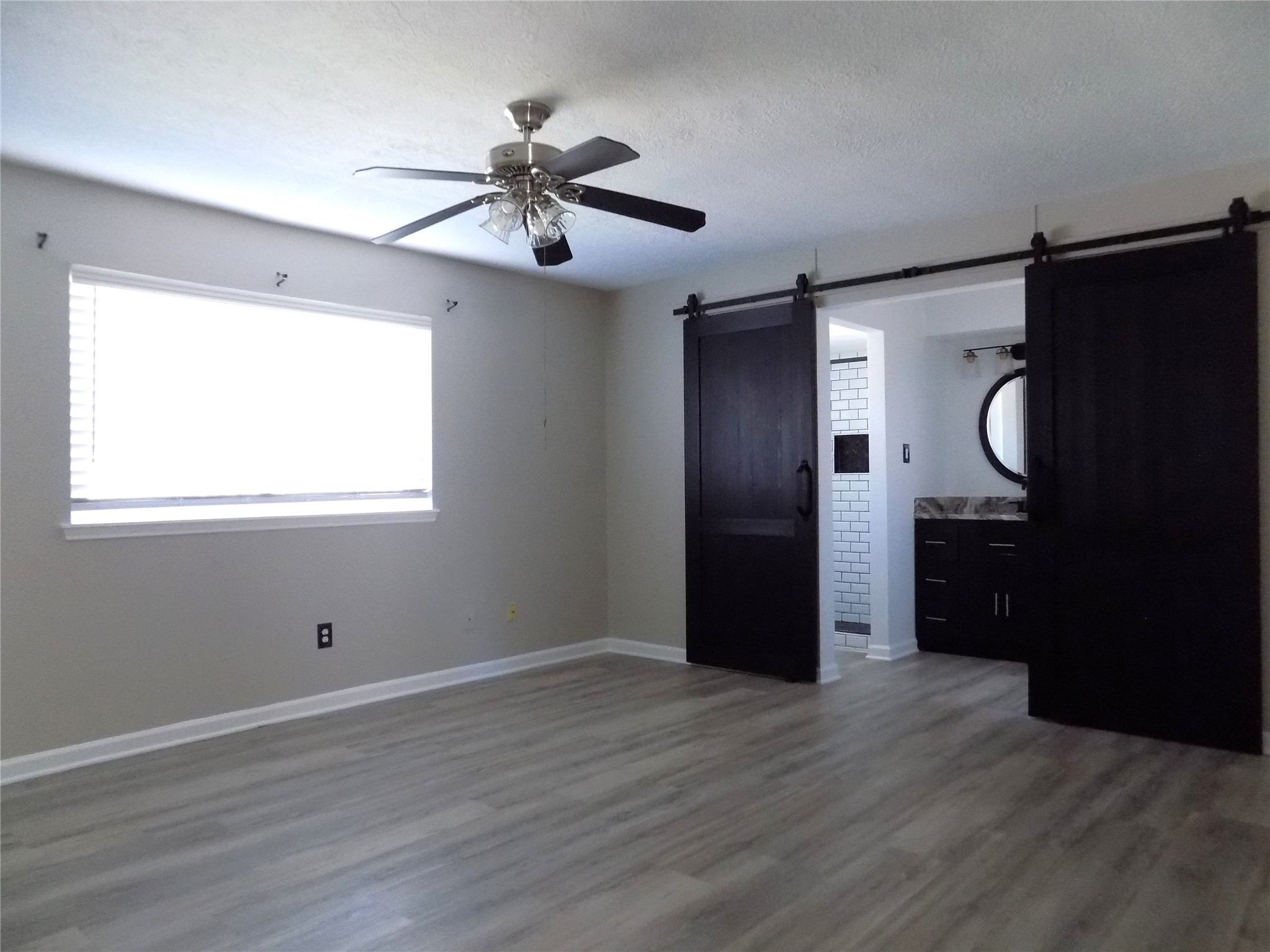 803 Wild Horse Valley Road Katy, TX 77450 - Photo 13 of 26 a view of an empty room with wooden floor and a window