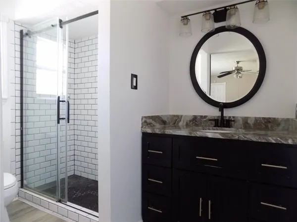 a bathroom with a sink a toilet and a mirror