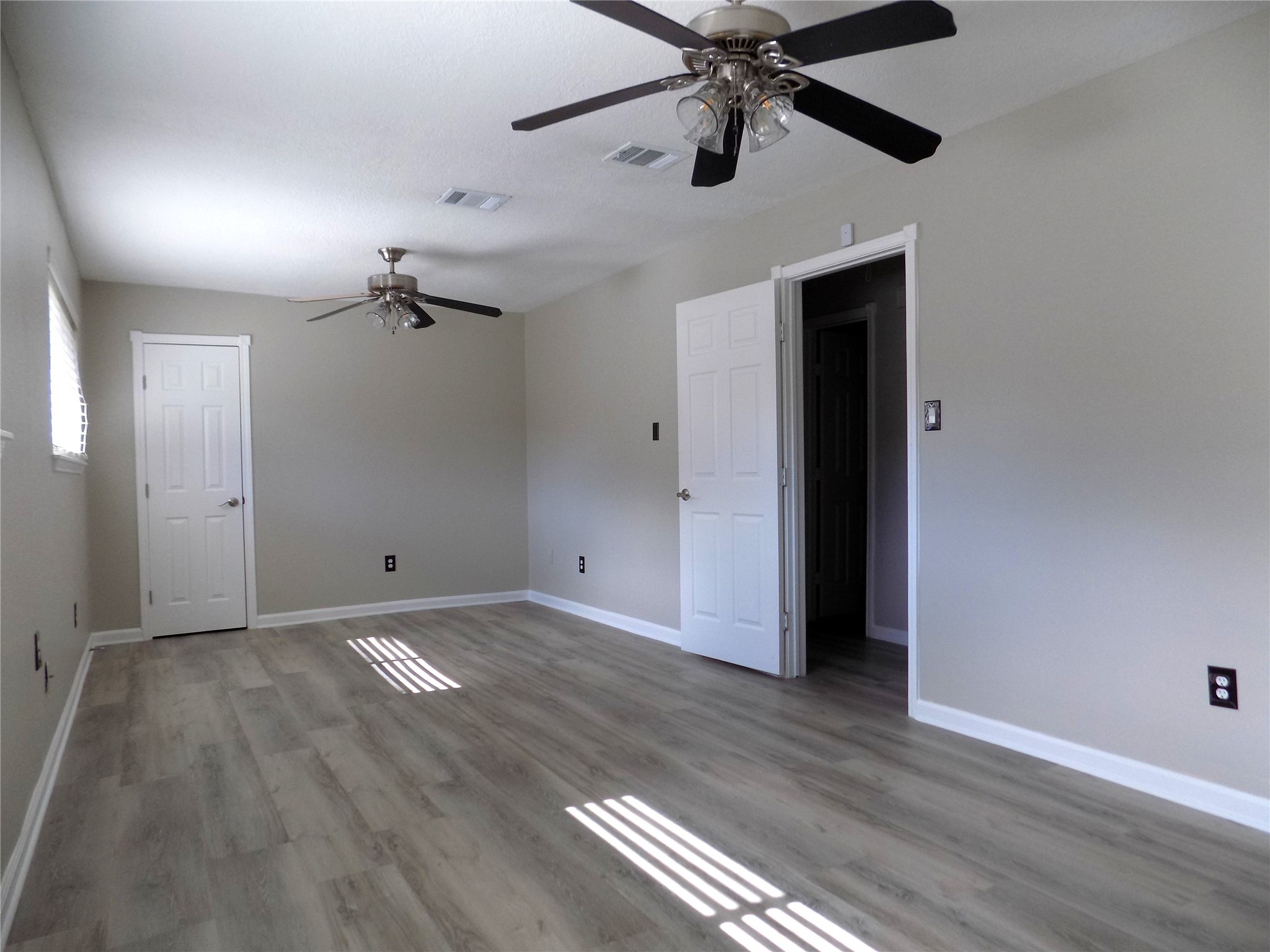 803 Wild Horse Valley Road Katy, TX 77450 - Photo 17 of 26 wooden floor in an empty room with a window