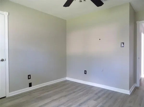 a view of a room with wooden floor
