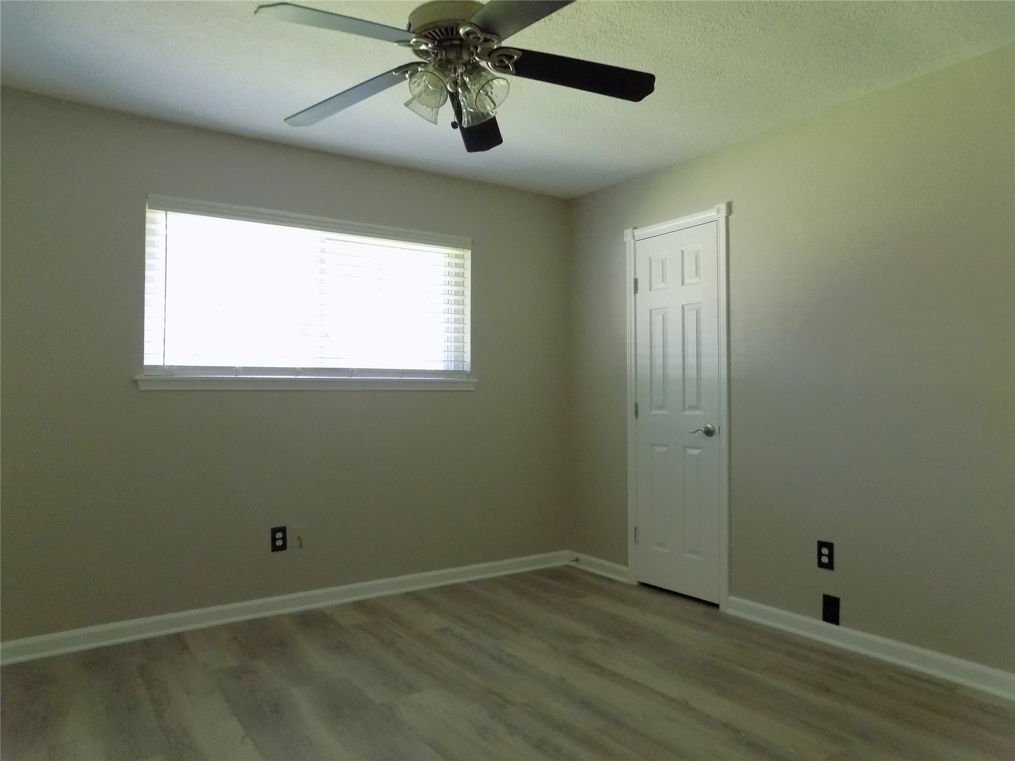 803 Wild Horse Valley Road Katy, TX 77450 - Photo 20 of 26 a view of an empty room with wooden floor and a window