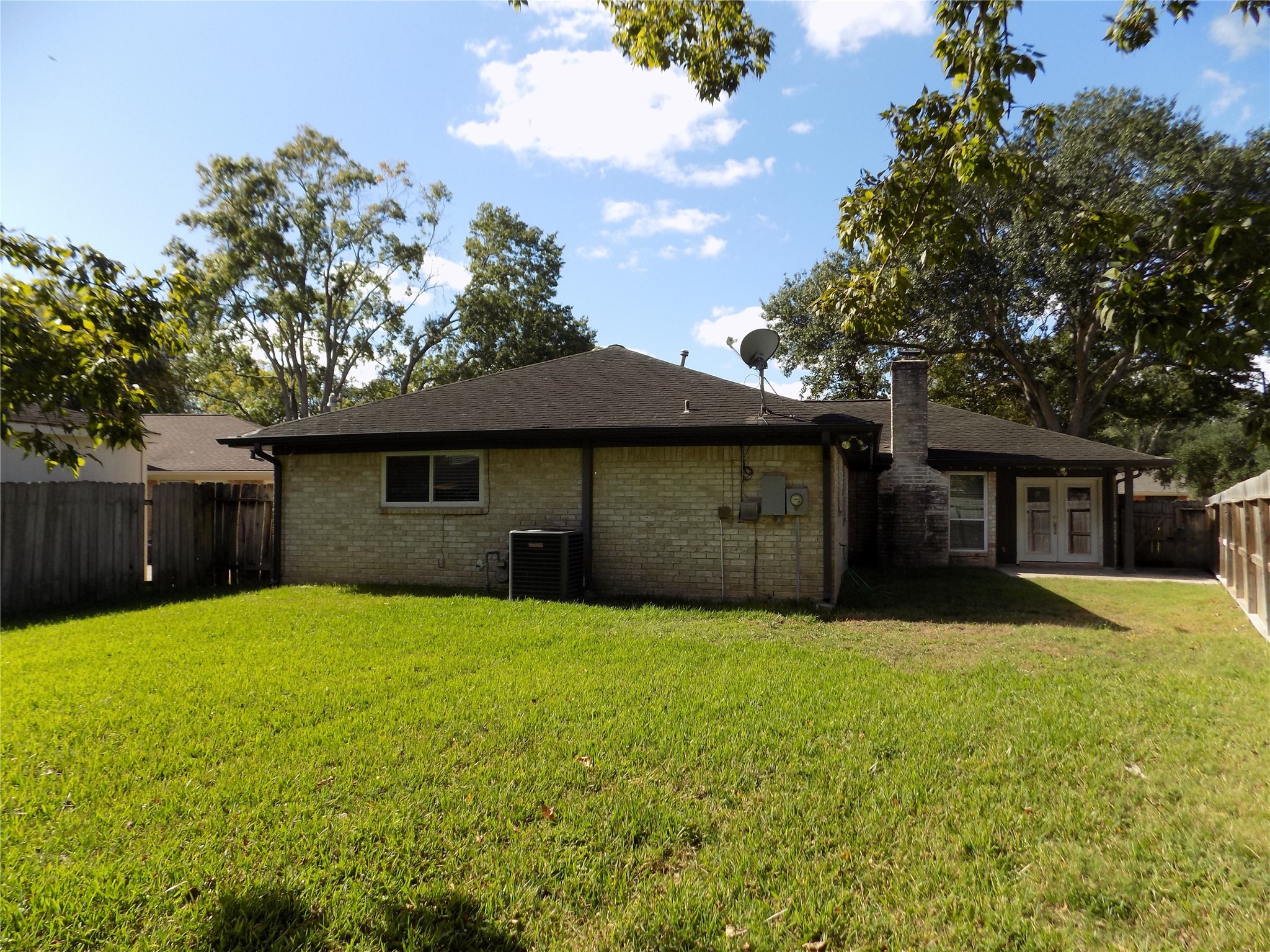 803 Wild Horse Valley Road Katy, TX 77450 - Photo 22 of 26 a brick house with a large tree in front of it