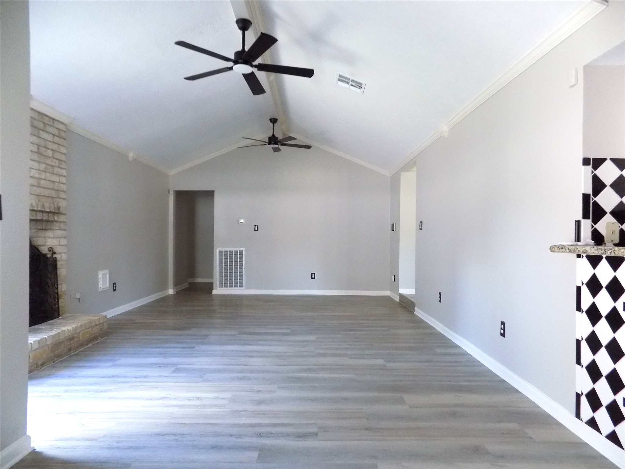 803 Wild Horse Valley Road Katy, TX 77450 - Photo 3 of 26 a view of an empty room with wooden floor and a window