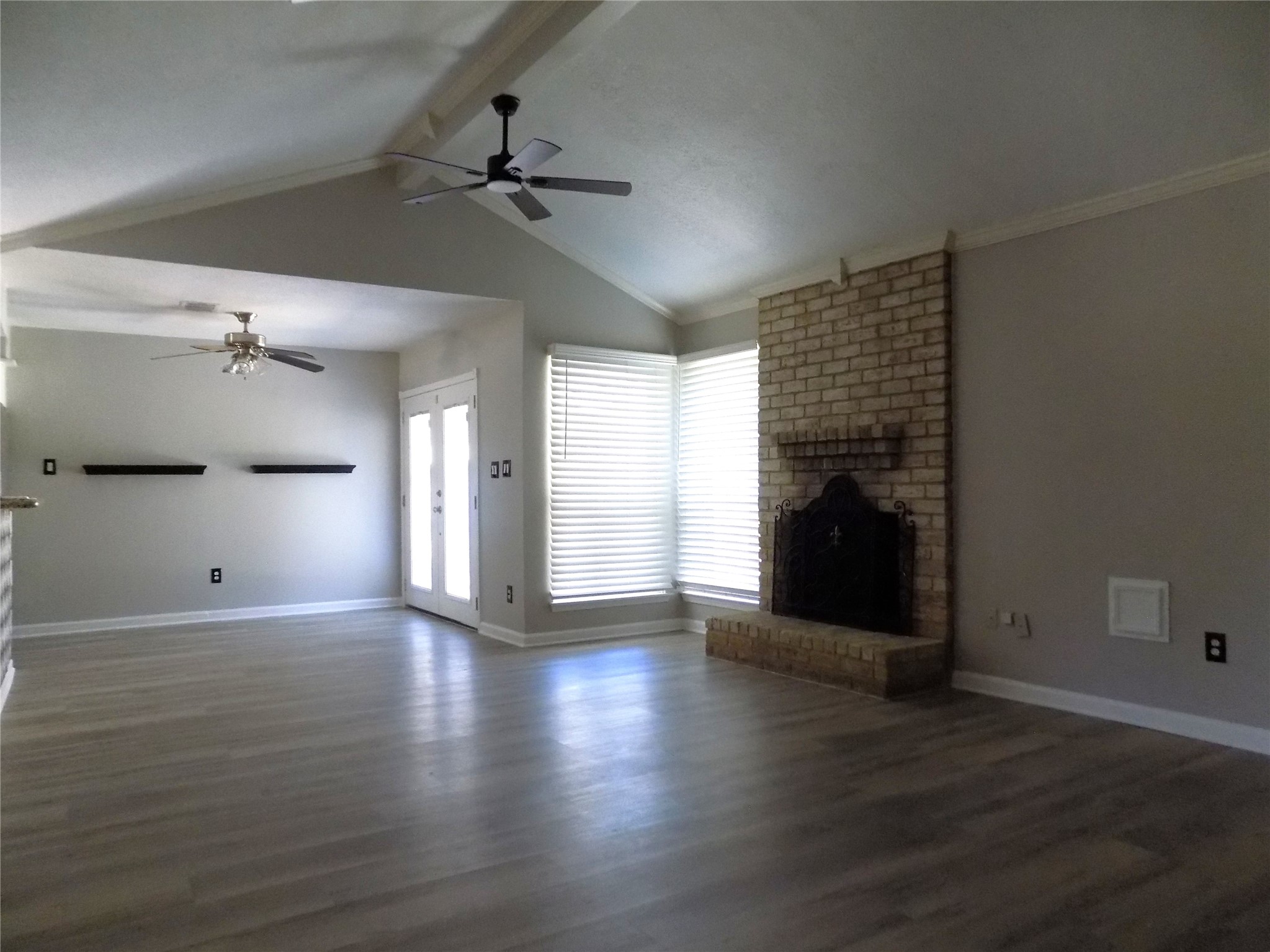 803 Wild Horse Valley Road Katy, TX 77450 - Photo 4 of 26 a view of empty room with wooden floor and a fireplace