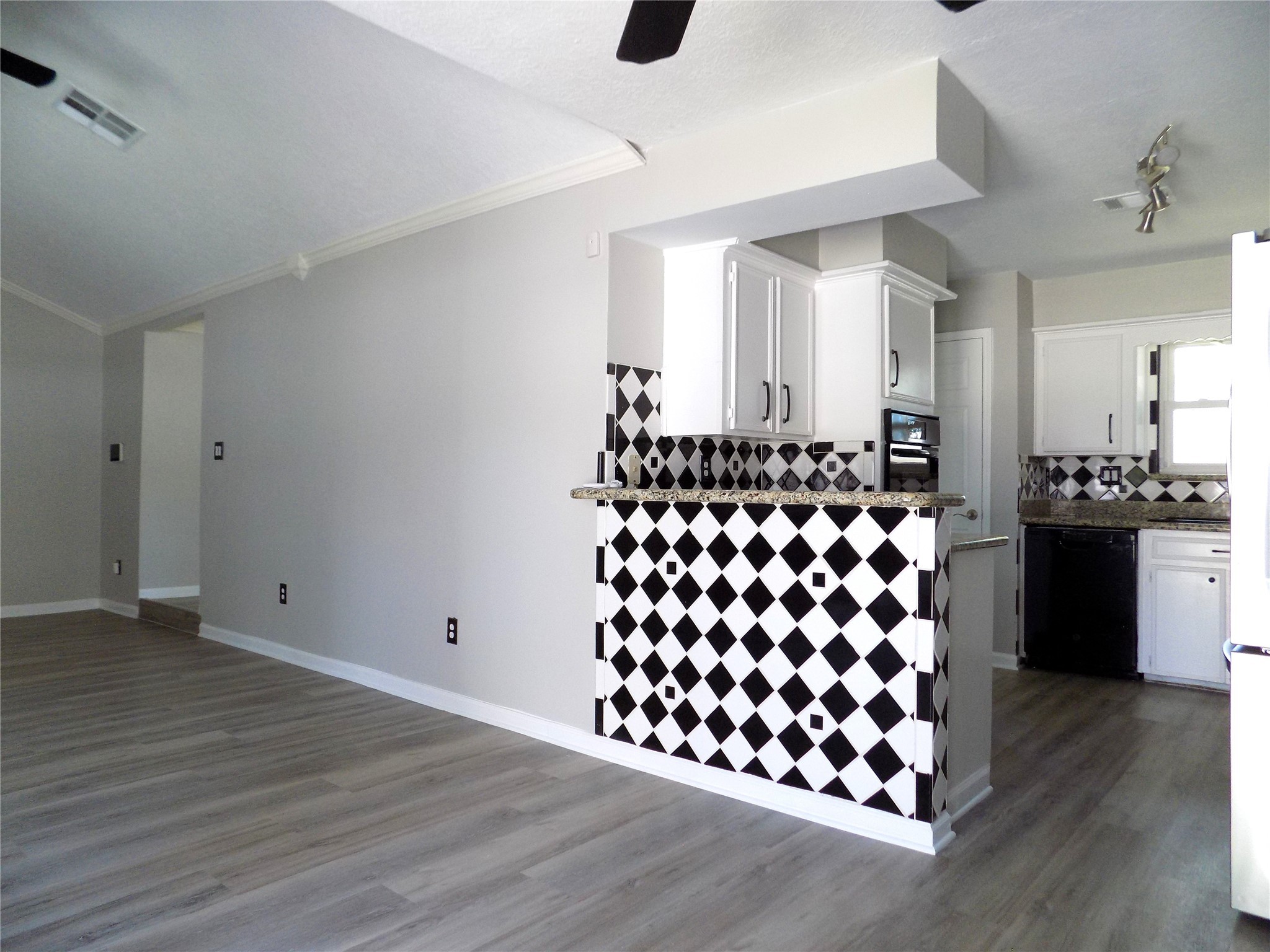 803 Wild Horse Valley Road Katy, TX 77450 - Photo 6 of 26 a kitchen with granite countertop a black white checkered floor