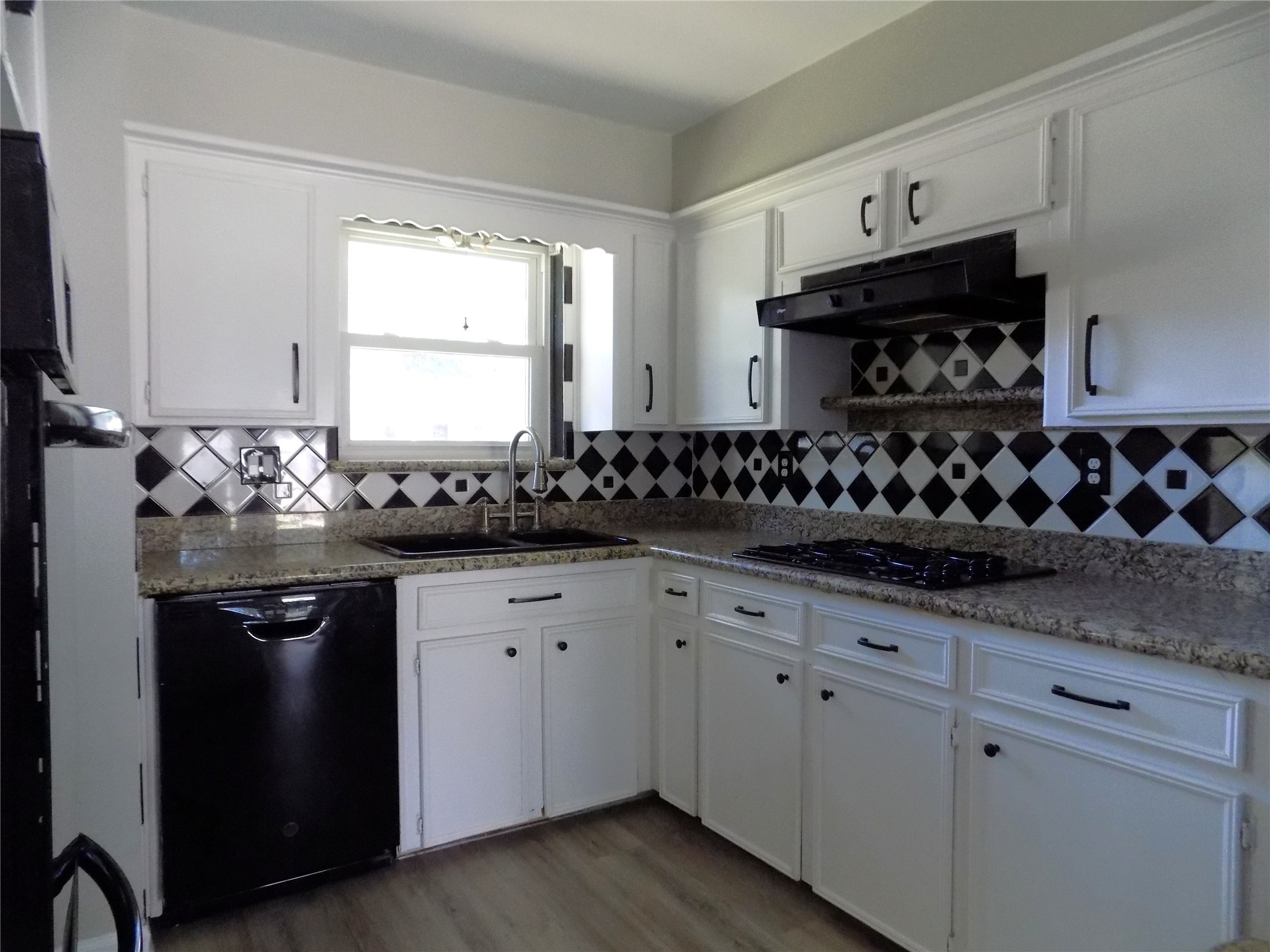 803 Wild Horse Valley Road Katy, TX 77450 - Photo 7 of 26 a kitchen with granite countertop a sink and cabinets
