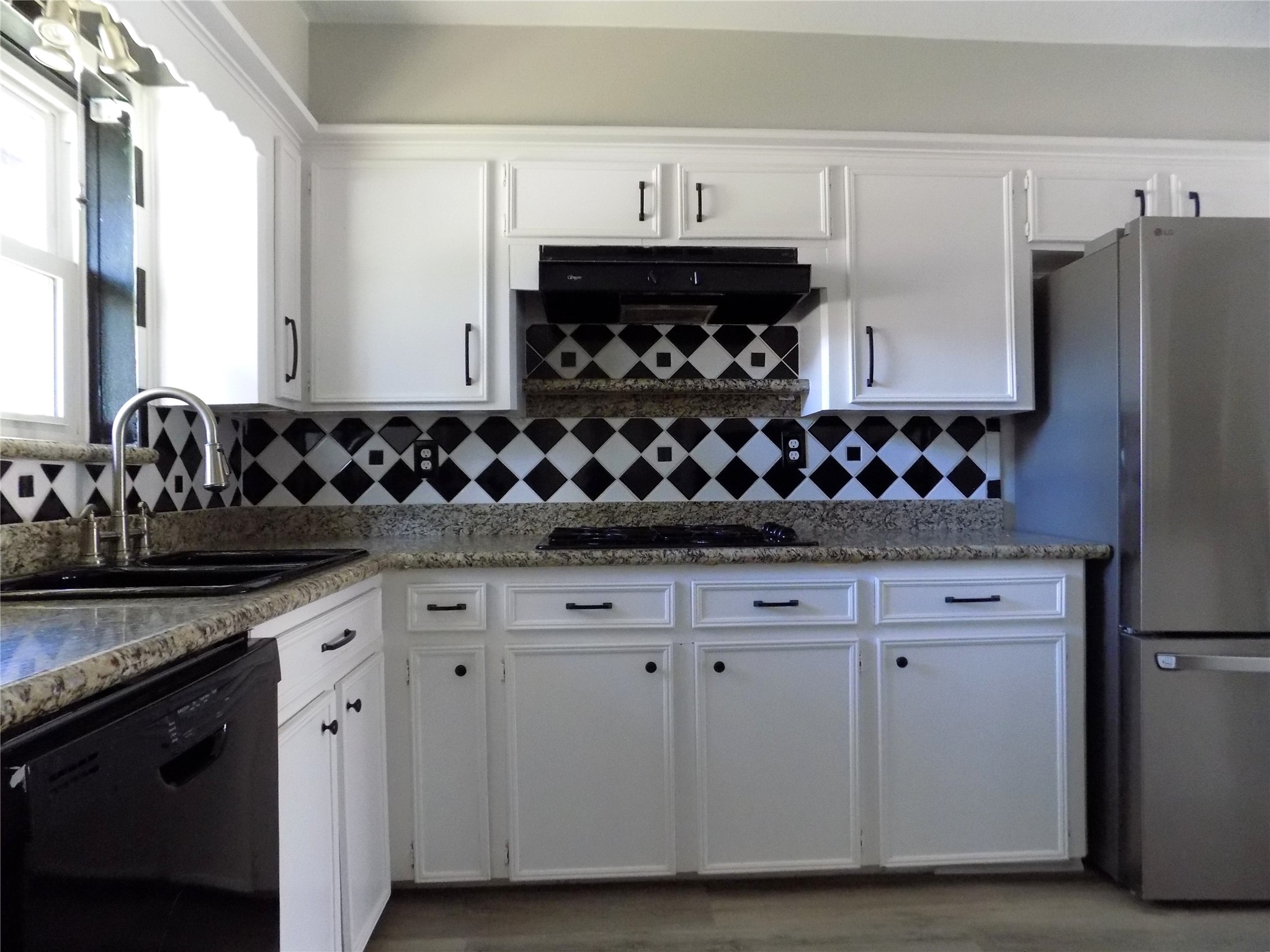 803 Wild Horse Valley Road Katy, TX 77450 - Photo 8 of 26 a kitchen with stainless steel appliances granite countertop a sink stove and refrigerator
