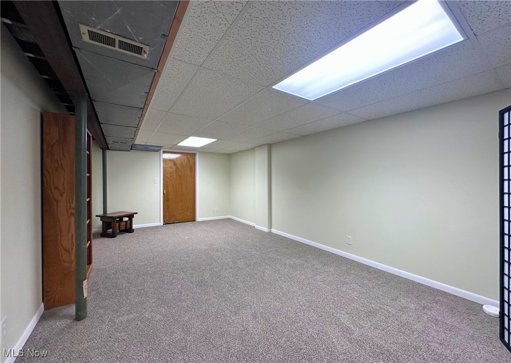157 Birch Road Painesville, OH 44077 - Photo 23 of 41 Finished basement with a drop ceiling, carpet flooring, and baseboards