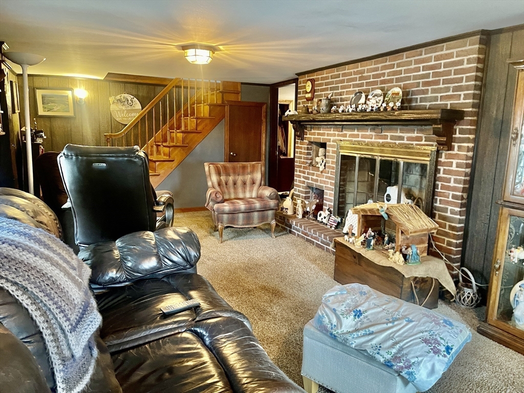 70 Wheaton Avenue Rehoboth, MA 02769 - Photo 14 of 42 a living room with furniture gym equipment and a fireplace