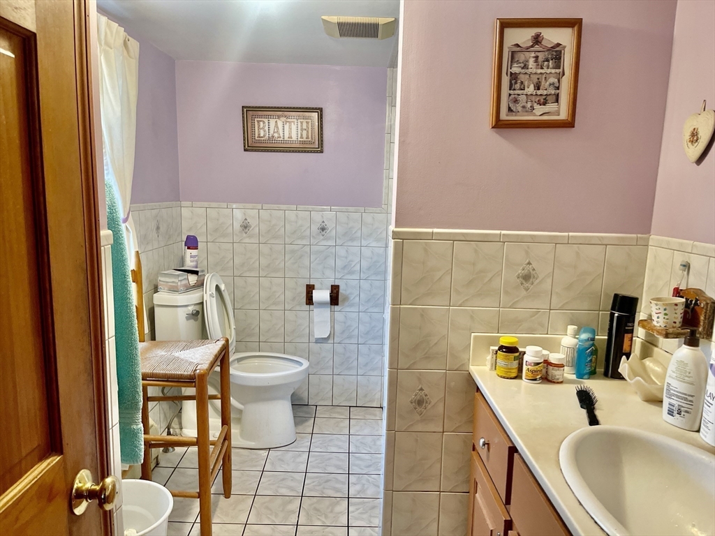 70 Wheaton Avenue Rehoboth, MA 02769 - Photo 15 of 42 a bathroom with a sink a toilet and a mirror