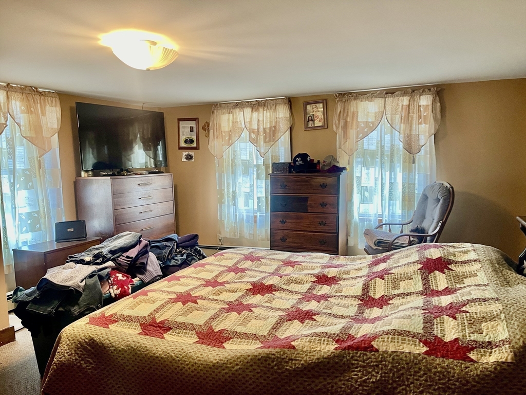 70 Wheaton Avenue Rehoboth, MA 02769 - Photo 17 of 42 a bedroom with a bed and dresser with mirror