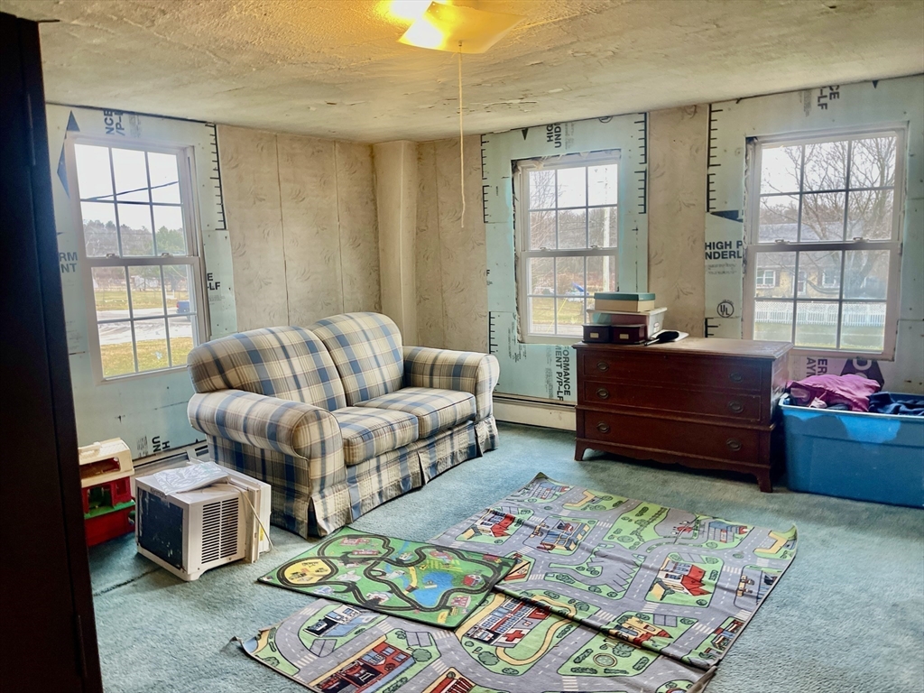 70 Wheaton Avenue Rehoboth, MA 02769 - Photo 18 of 42 a living room filled with furniture and a window