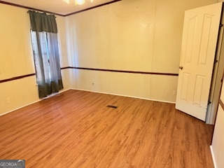 1572 Triple T Drive Dewy Rose, GA 30634 - Photo 13 of 18 a view of a room with wooden floor and a hallway