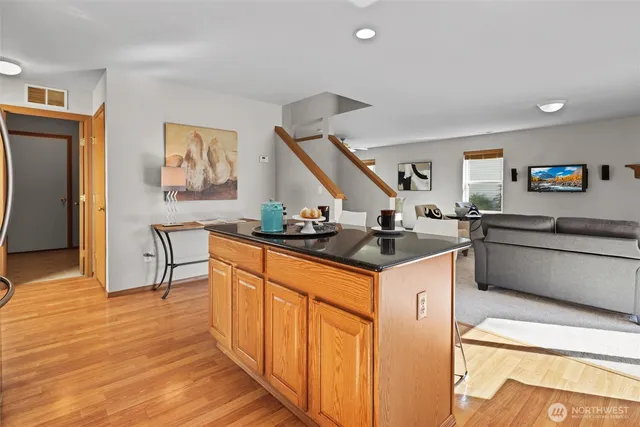 a kitchen with granite countertop a sink and a stove top oven