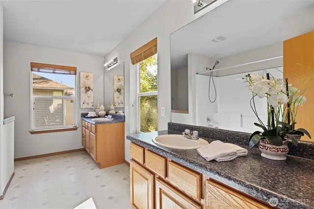 a bath room with sink and mirror