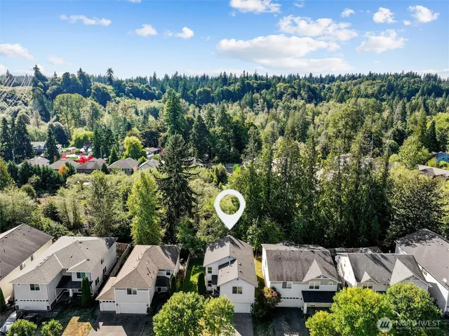 an aerial view of a house with a yard
