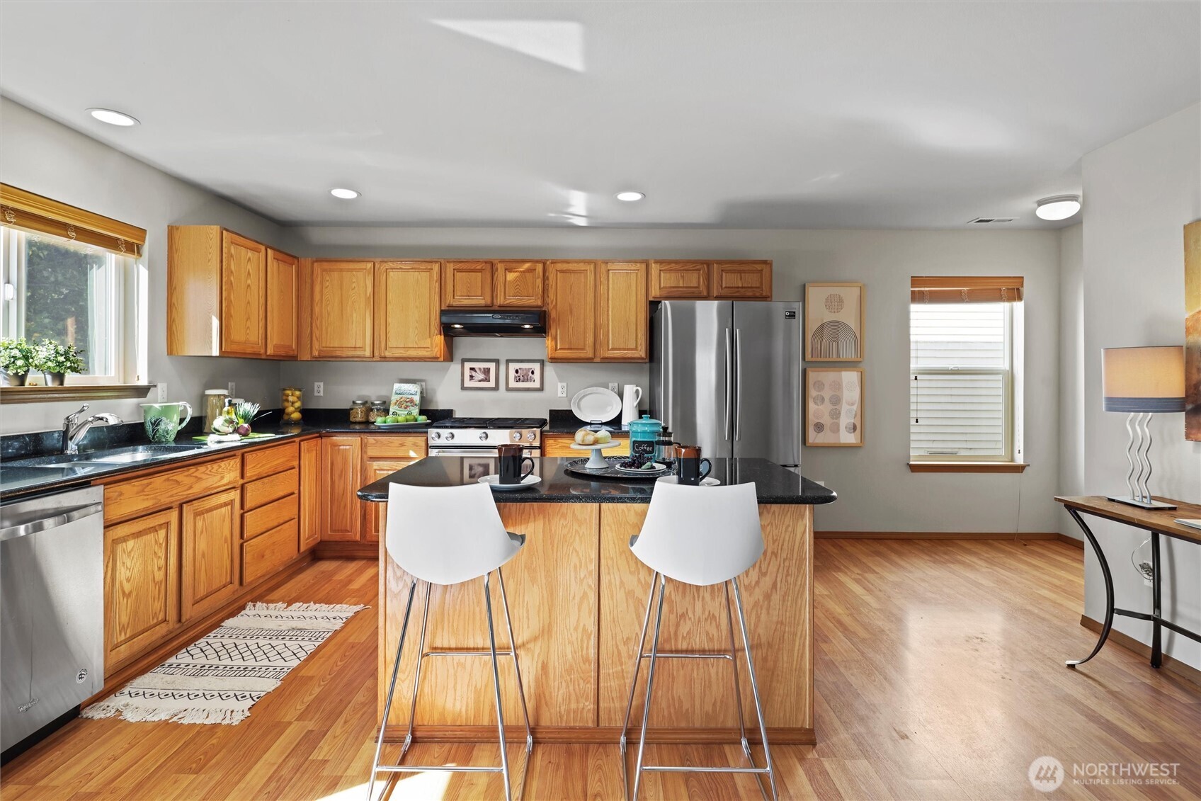 19002 13th Avenue Southeast Bothell, WA 98012 - Photo 8 of 36 a kitchen with stainless steel appliances granite countertop a stove a sink and a refrigerator