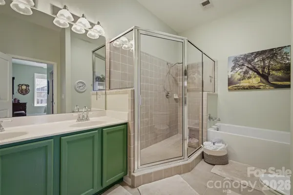 a bathroom with a granite countertop sink a toilet and shower